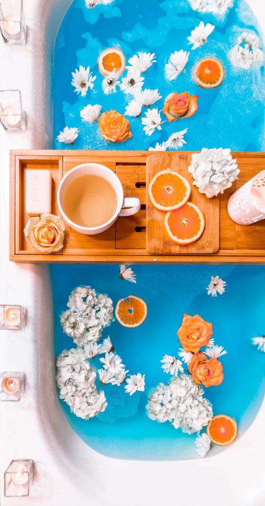 tea and oranges and flowers in a bathtub